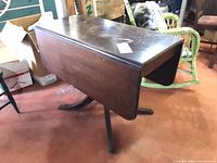 Table with both leaves folded down showing pedestal legs