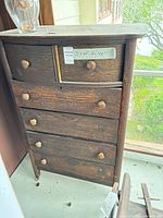 Front view of solid wood dresser showing all drawers, knobs and overall wear