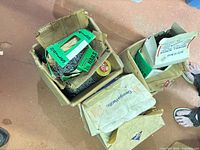 Multiple open cardboard boxes containing smaller nail and screw cartons