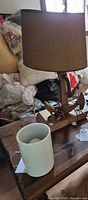 Wooden anchor table lamp and white cylindrical lamp on tabletop