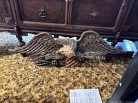 Full view of metal eagle plaque under furniture