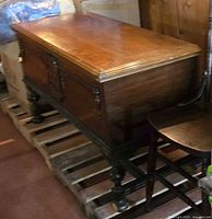 Full view of chest showing top, legs, and stretcher base