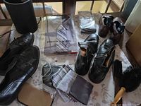 Overview of shoes, shirt with tie, pocket squares, shoe brush and accessories