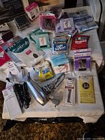 Table view of packaged hosiery, hair dryer, curling irons