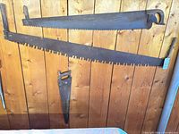 Two-man and one-man crosscut saws hung on wall