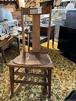 Full front view of the oak rocking chair showing overall design and dimensions