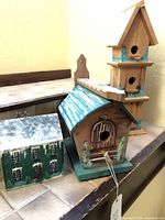 All three wooden birdhouses displayed together