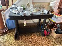 Front view of the solid wood entry table with items on top