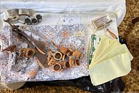 Overall lot view with napkins, wooden napkin rings, salad servers, metal napkin rings and crumb catcher