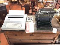 Both typewriters side by side on table