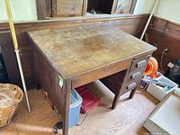 Overall view of desk showing top surface wear and drawer configuration