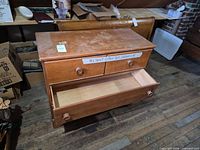 Front view showing all three drawers, lower drawer open