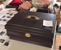 Closed dark wooden jewelry box with handle and lock