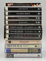 Stack of cassette cases showing spine labels for all eight audiobook sets