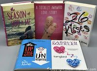 Front view of all five books standing