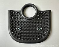 Front view of black silicone bubble pop handbag showing two blue eye accents and round handle