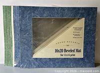 Stack showing blue and green beveled mats with packaging insert