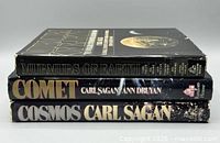 Spine view of Murmurs of Earth, Comet, Cosmos showing titles, authors, publisher logos
