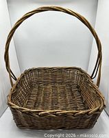 Three-quarter view of basket showing square shape, handle, and woven pattern