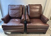 Front view of both leather armchairs side by side