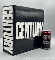 Front cover of Century book next to soda can for scale