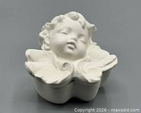 Angled view of ceramic cherub trinket box with lid on