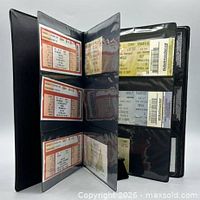Album open showing multiple ticket stubs in plastic sleeves