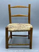 Front view of small wood chair with woven seat