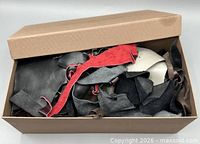 Shoebox with lid partially off showing mixed leather scraps