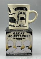 Mug on top of box showing graphics and title