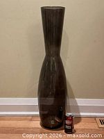 Full view of IKEA Fyllig black glass floor vase with soda can for scale