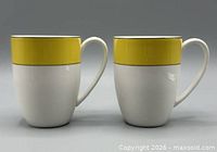 Front view of both mugs showing yellow band design