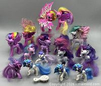 Group of 15 My Little Pony figures and brush displayed