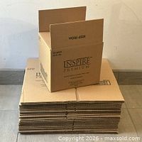 Stack of flat boxes with one partially assembled on top