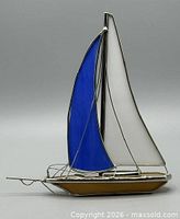 Front view of stained glass sailboat showing blue and white sails