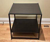 Front view of square side table showing top and shelf