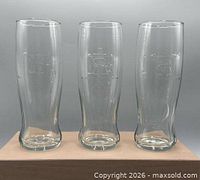 Front view of three identical Vancouver 2010 pilsner glasses