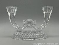 Front view of clear pressed glass double-arm candle holder