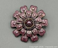 Front view showing pink enamel petals, rhinestones, faux pearl centre