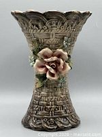 Full front view of vase showing floral appliqué and basket-weave texture