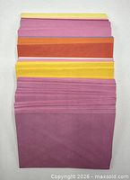 Stack of assorted coloured envelopes fanned to show pink, yellow, orange shades