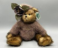 Front view of Bearington "Collette" teddy bear seated, showing sweater, hat with rose, tag