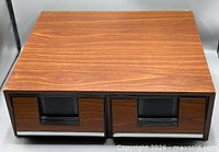Front view showing faux wood grain finish and two drawers
