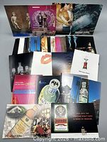 Overview of assorted advertising postcards laid out showing various brands and designs