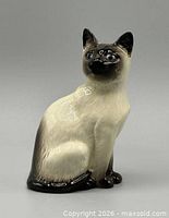 Front view of glazed porcelain Siamese cat figurine