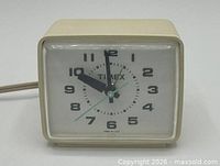 Front view of Timex alarm clock showing dial and hands