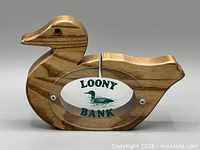 right-side view of wooden duck coin bank displaying acrylic window and LOONY BANK graphic