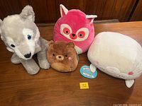 Front view showing all four Squishmallows on table