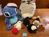 Group view of all eight plush toys on table