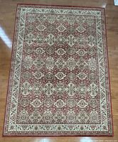 Full view of rectangular red ivory beige medallion rug